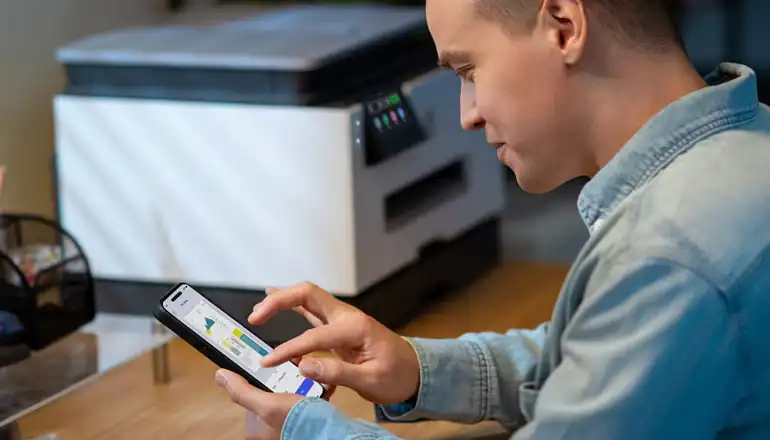 Man printing off a HP printer from his phone.