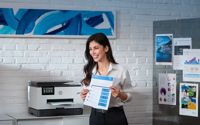 HP printer on desk printing out a paper.