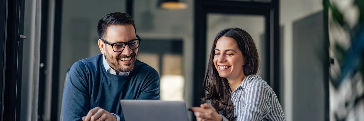 people smiling at a laptop