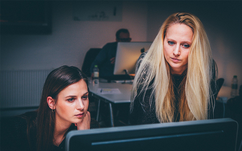 Two women looking at computer