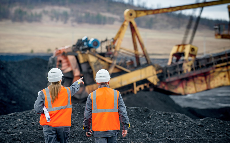 Two people assessing a mining site