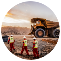 Mining pit with workers and equipment.