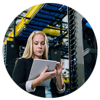 Female walking through datacentre with tablet.