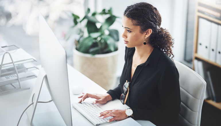 Business professional watching webinar on desktop computer