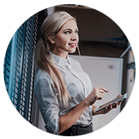 Smiling businesswoman uses touch screen on tablet device in data center