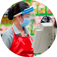 Woman in facemask and faceshield working in-store