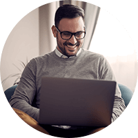 Happy man working using a laptop