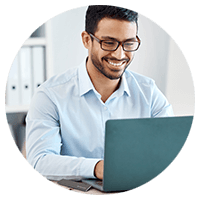 Man with glasses using a laptop