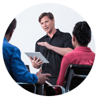 Male Professional Holding a Tablet, Giving an Overview and Training to his Clients.