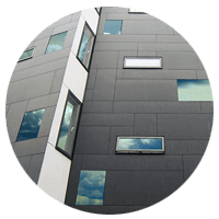 Modern building with clouds reflected through multiple windows