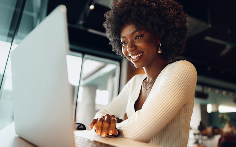 Woman working on laptop smiling