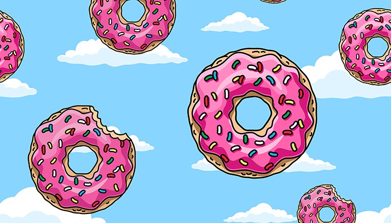 Cartoon donuts with pink glaze and colored sprinkles on white background. Seamless pattern. Texture for fabric, wrapping, wallpaper. Decorative print.