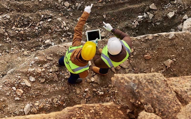 Construction worker on tablet device outside