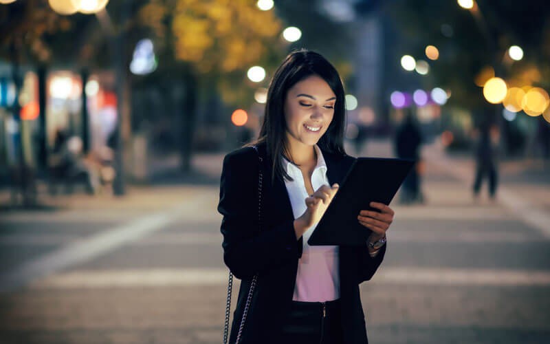 Woman in city using tablet device