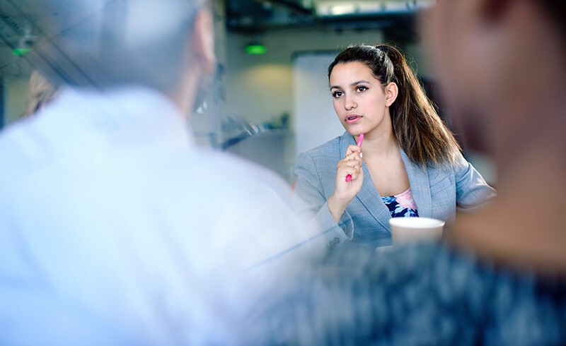 Female business woman asking question to training team