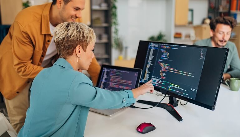 Girl pointing at computer at work