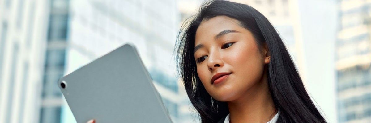 Businesswoman with tablet outside in city