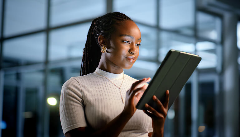 Girl smiling at tablet at work