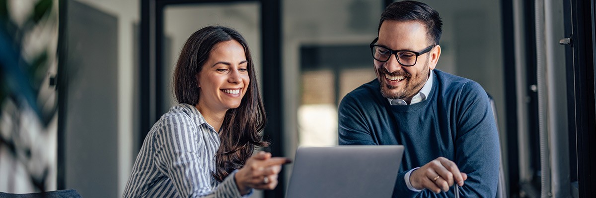 Two users collaborating on laptop