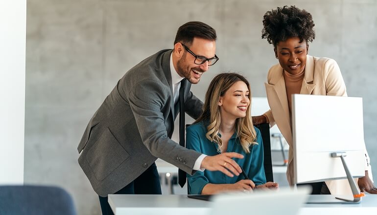People smiling at a desktop