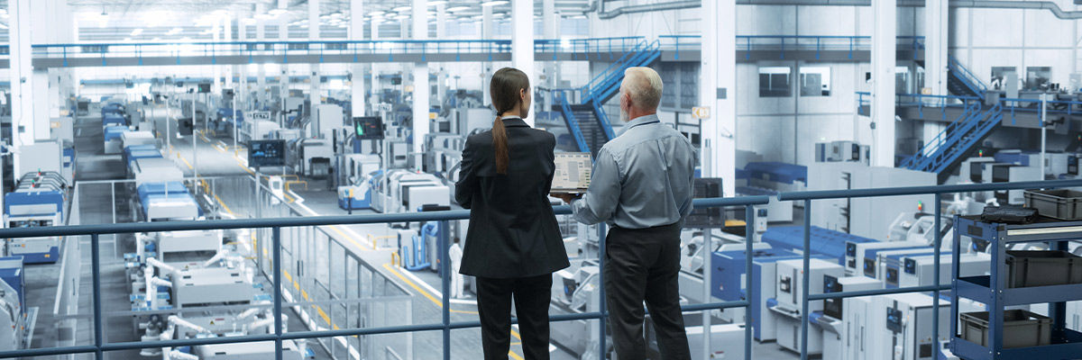 Workers looking off into factory