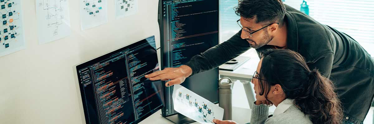 Two people looking at a desktop