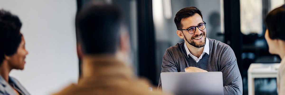 Workers in office with laptops