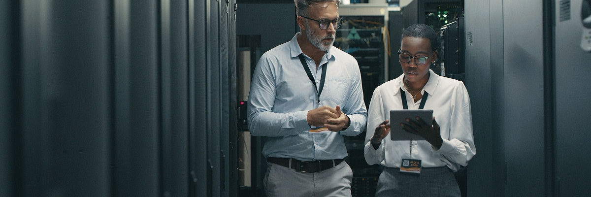 Security room experts looking at a tablet