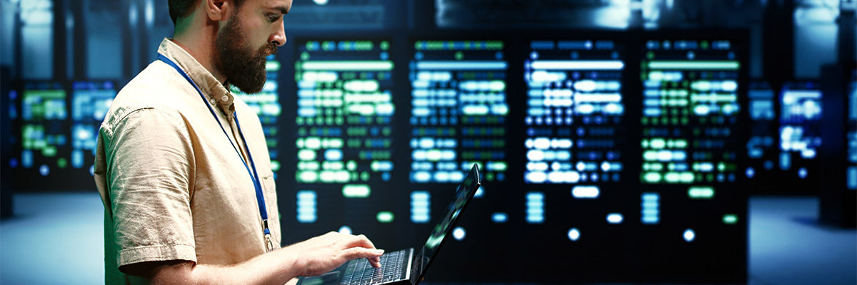 Man on laptop in IT room