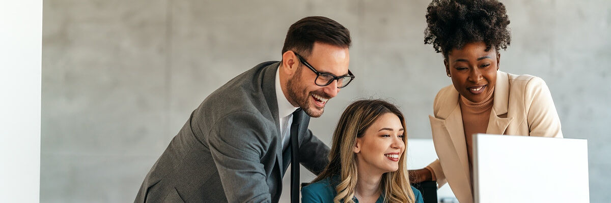 people smiling at a computer