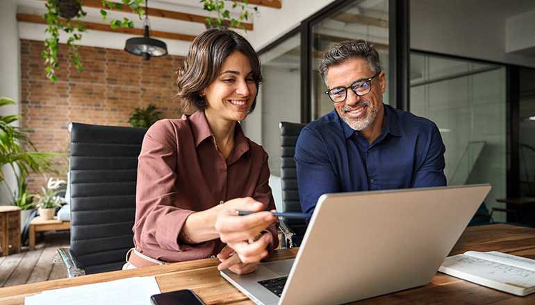 People smiling at a laptop