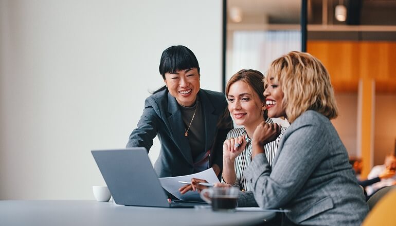 People smiling on a laptop