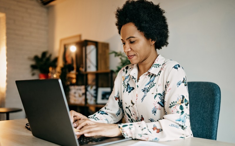 Businesswoman working from home using laptop computer