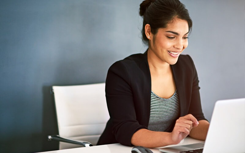 Key recommendations from Cisco Woman reviewing information found in a report from her desktop computer