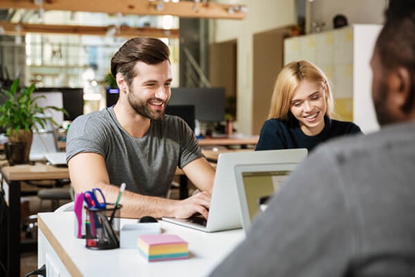 Coworkers working on their laptops