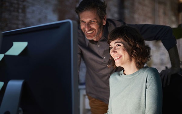 Learn how to close the gaps in cloud-based security Group of IT professionals gathered around computer reading security reports