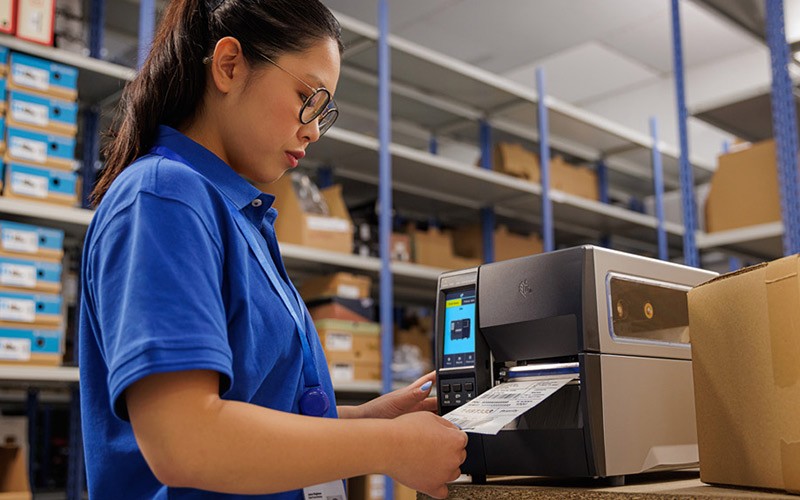 User in warehouse using Zebra device for retail operations