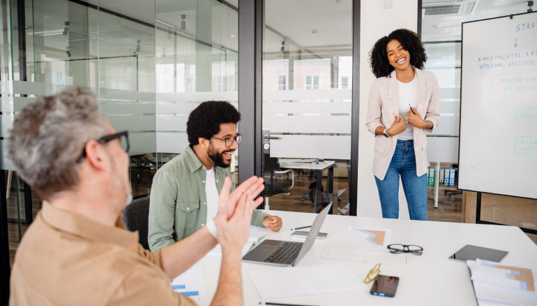 Someone in office presenting at whiteboard.