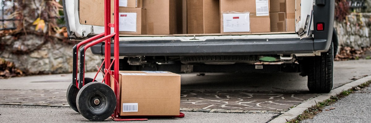 Close up of delivery van loading up packages