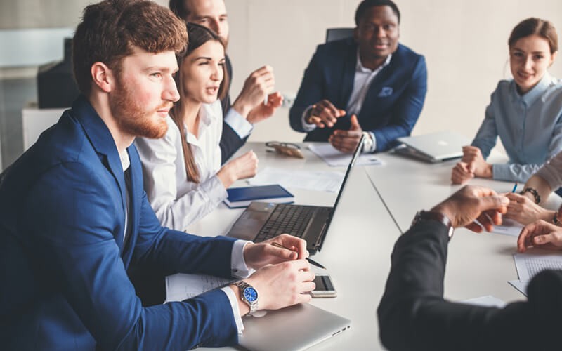 Group of business professionals gathered in meeting to discuss strategy