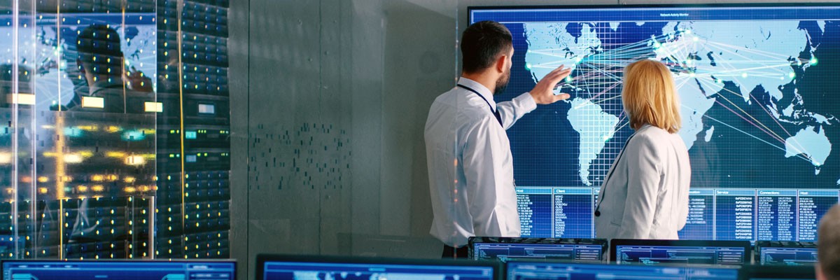 Software company employees monitor emergency situations on map