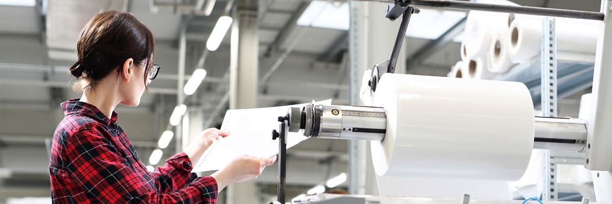 Ensuring Successful Adoption of SAP for a Global Paper Company Woman works with printer in global printing company