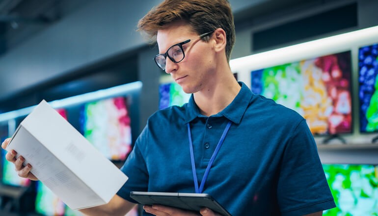 Sales manager in retail store expertly manages operations using tablet computer