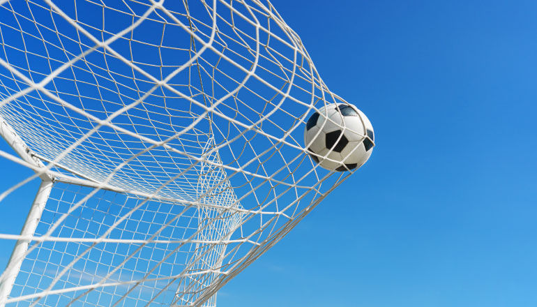 Soccer ball in goal.