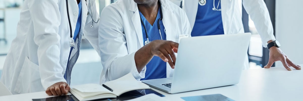 Doctors around laptop