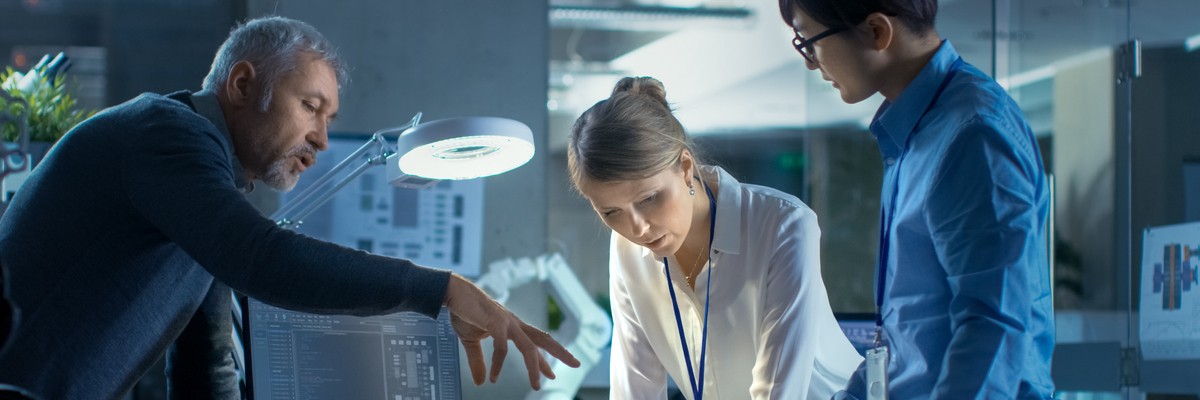 Team looking at computing equipment in clear cases
