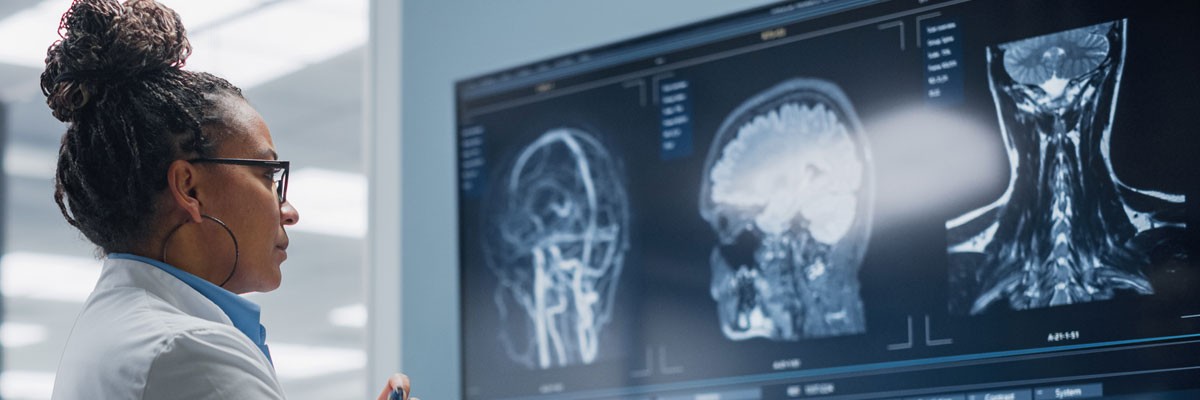 Medical Center Restores Regulatory Compliance and Resets Security Strategy Doctor reviews x-ray results on large screen in hospital