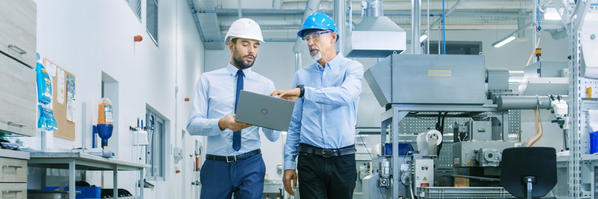 Two men walking through manufacturer warehouse