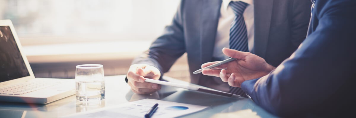 Software Provider Eliminates Downtime Amid Rapid Expansion Two corporate coworkers using a tablet