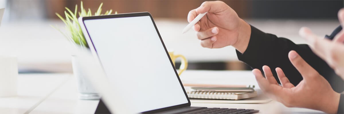 Close up of a business professional working on a tablet computer. Cisco security, client story, ISE enforcement